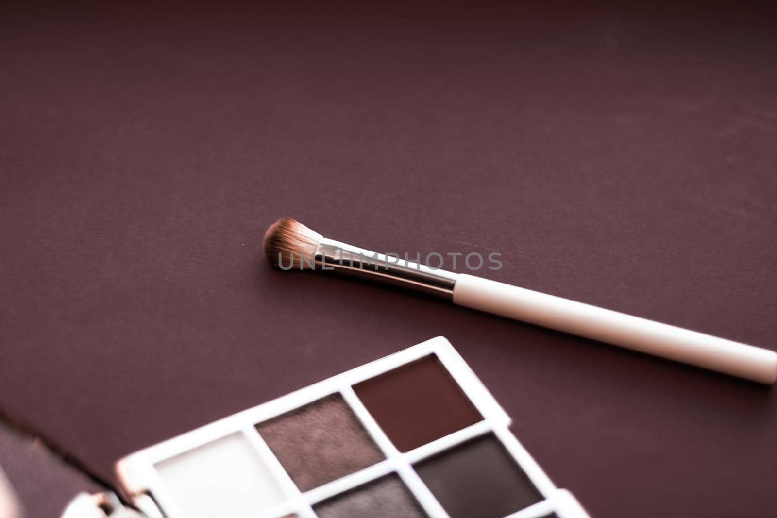 Cosmetic branding, mua and girly concept - Eyeshadow palette and make-up brush on chocolate background, eye shadows cosmetics product for luxury beauty brand promotion and holiday fashion blog design