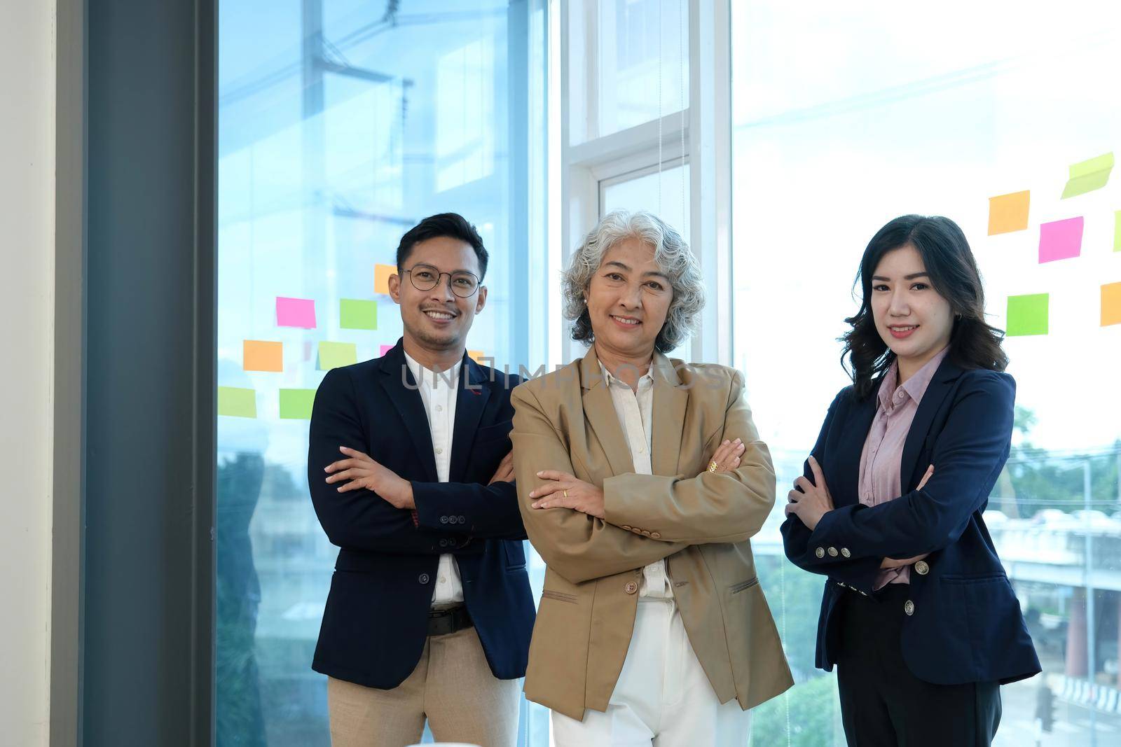 Group portrait of smiling professional business team looking at the camera by wichayada
