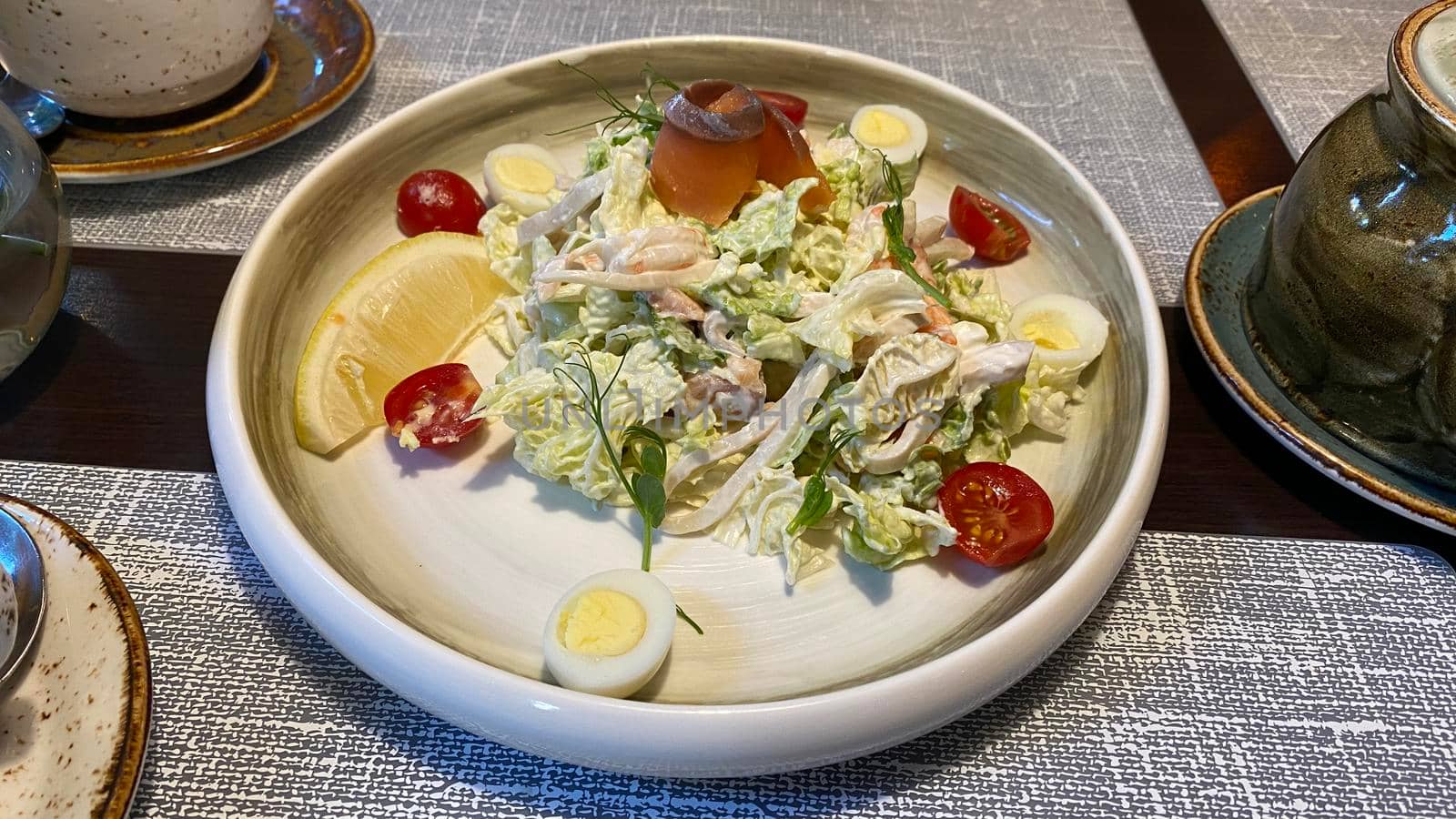 A large plate with seafood salad on the table