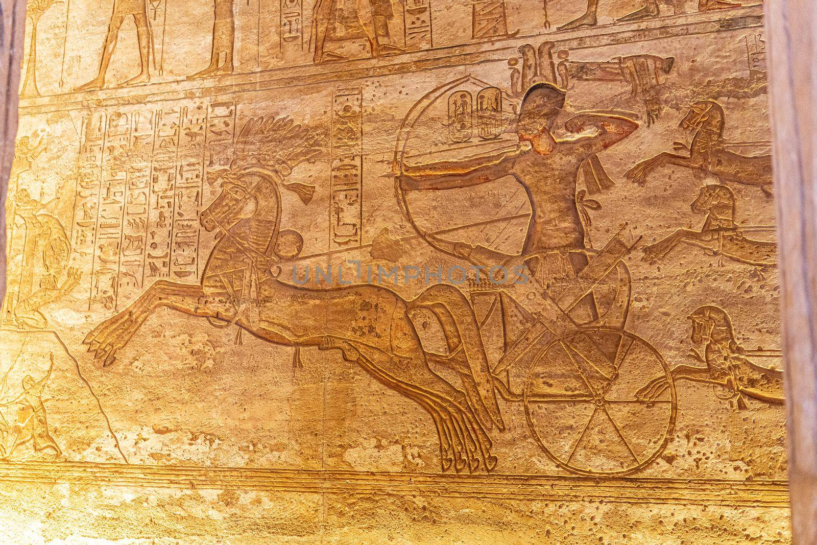 Fresco engraved on an Egyptian temple wall of a man on a horse fighting a war