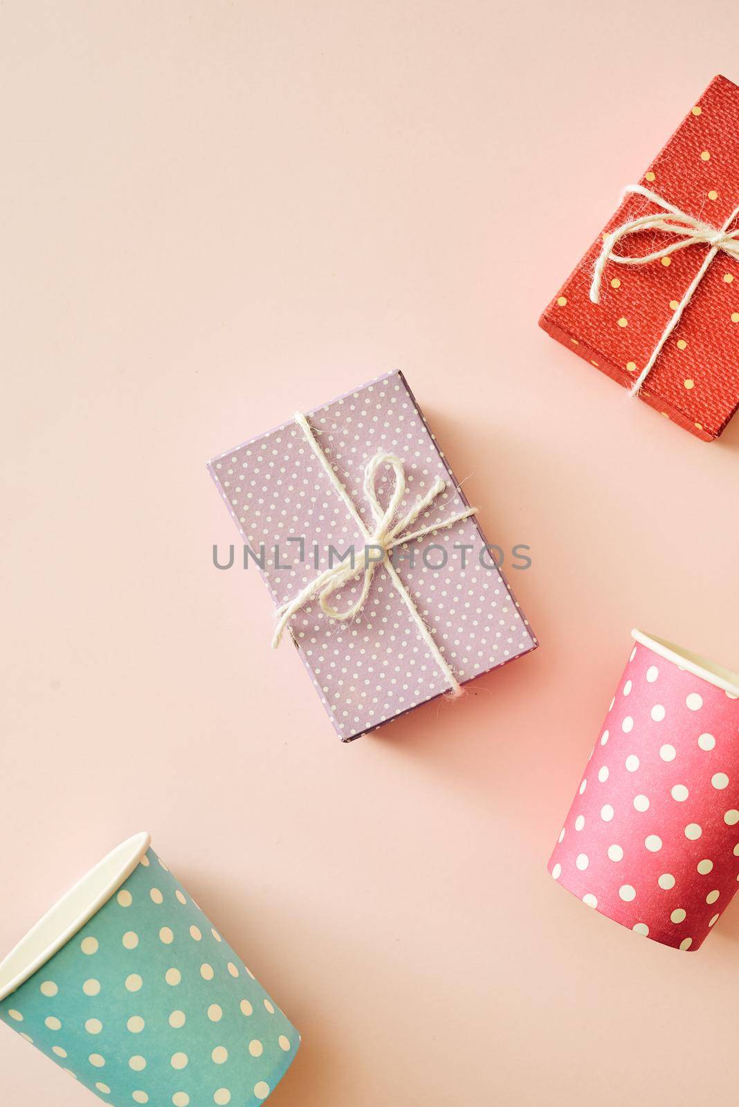 Fashion party background with colorful gift boxes on pink background