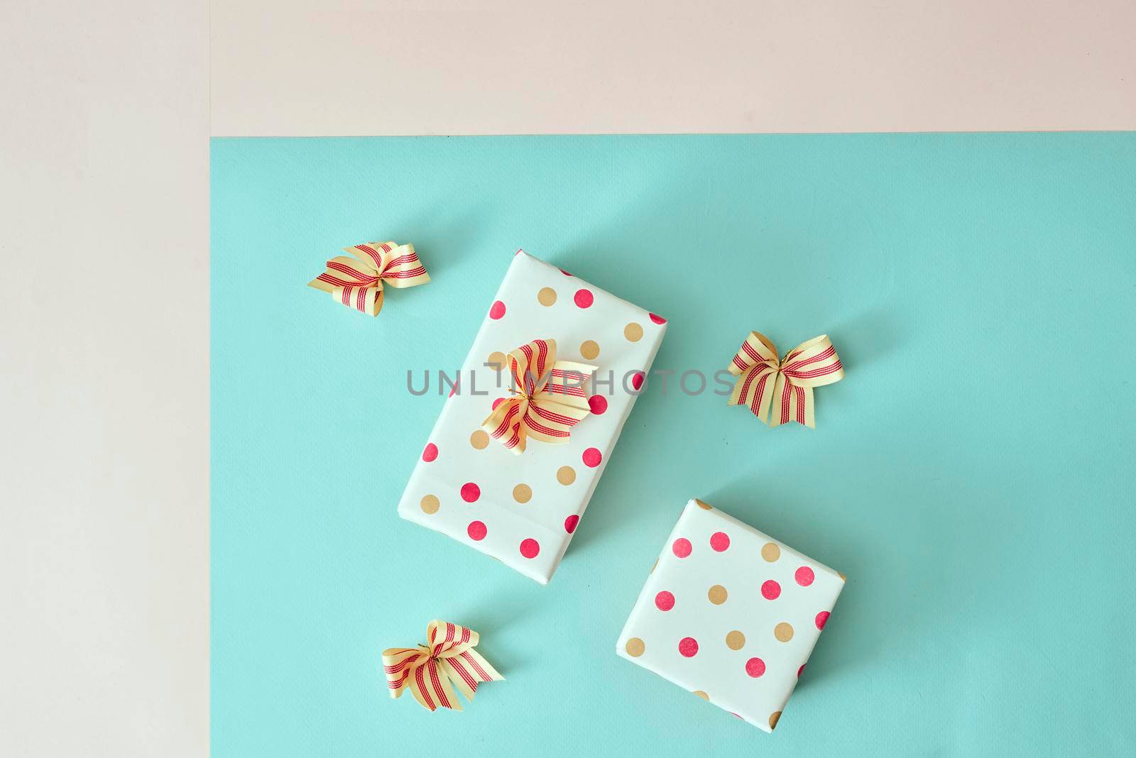present boxes with ribbon on pink canvas background by makidotvn