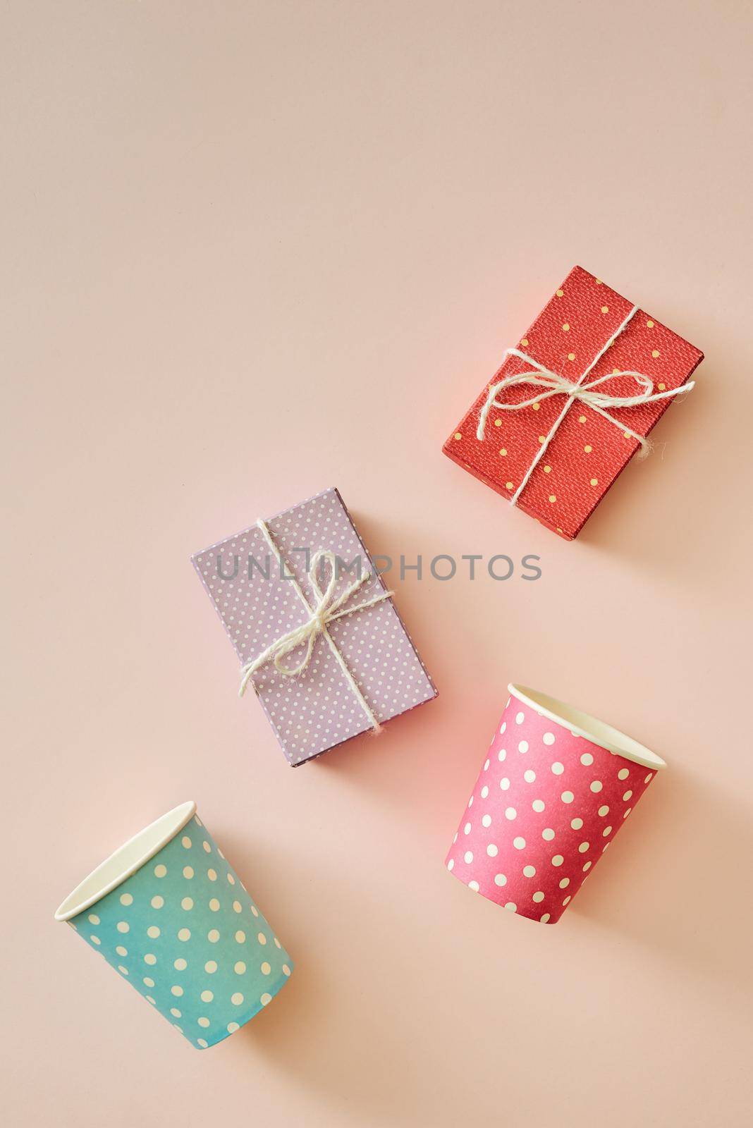 Cups and gift boxes wrapped in polka dots colorful paper