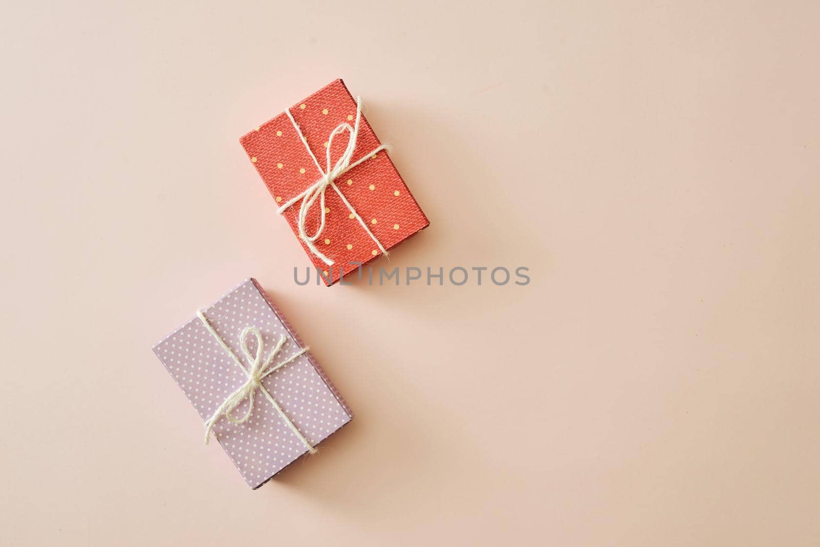 Flatlay with gifts in wrapped boxes top view on pastel color background by makidotvn