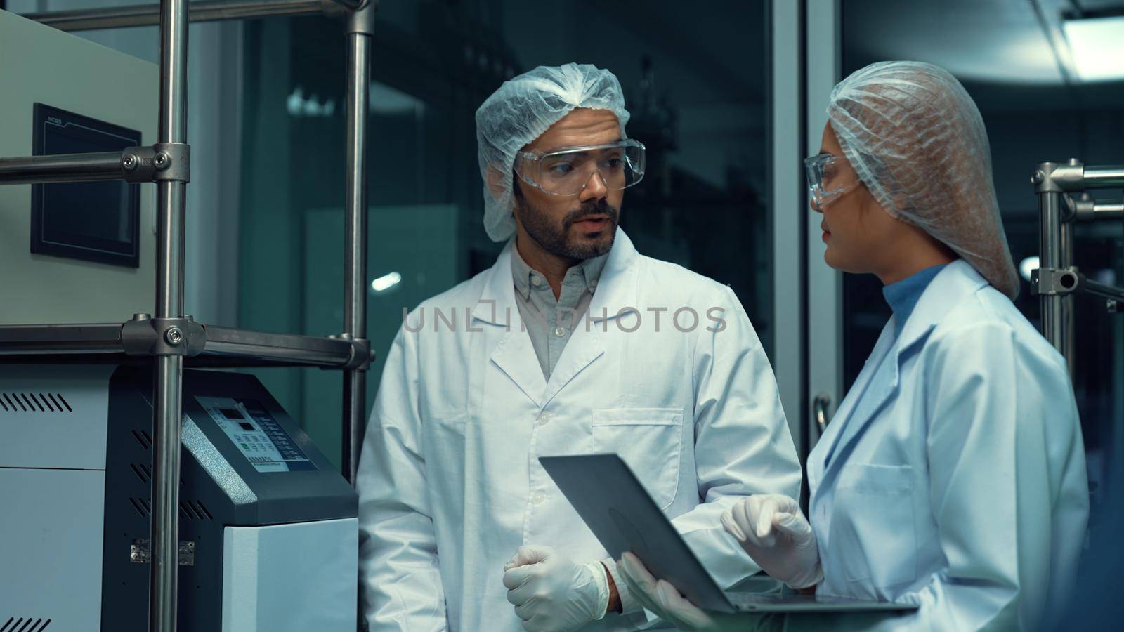 Two scientist in professional uniform working in laboratory for chemical and biomedical experiment