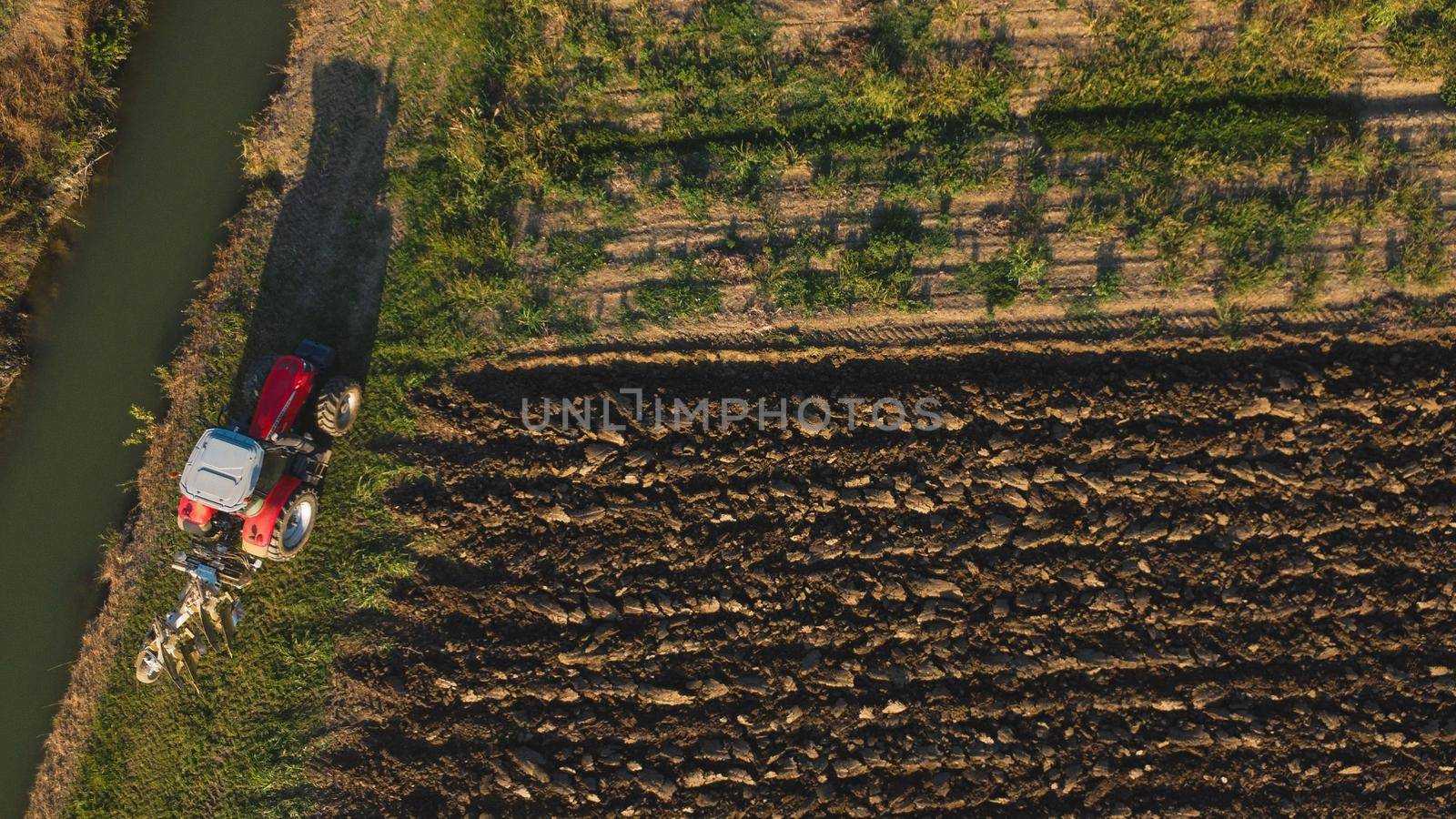 Monitcelli, Italy PC - September 2022 Tractor plowing the land in the fields by verbano
