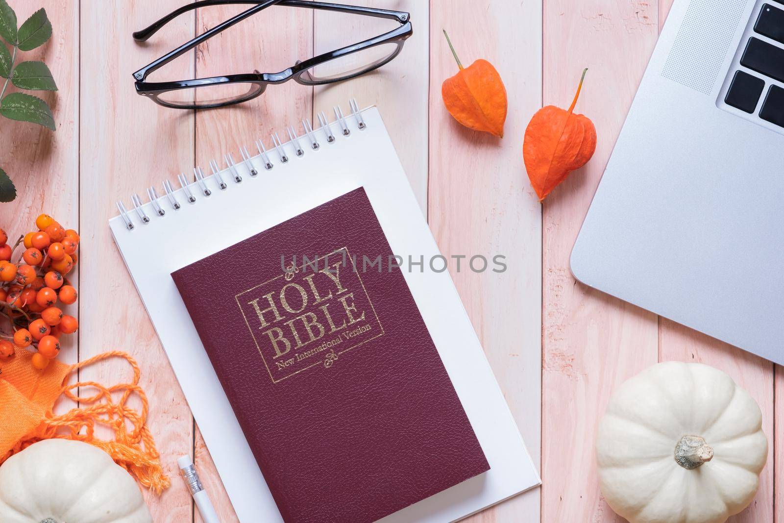 Holy bible and autumn cozy top view on wooden background. Bible study autumn concept.