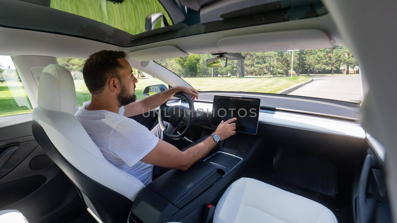 Caucasian man driving a modern electric car