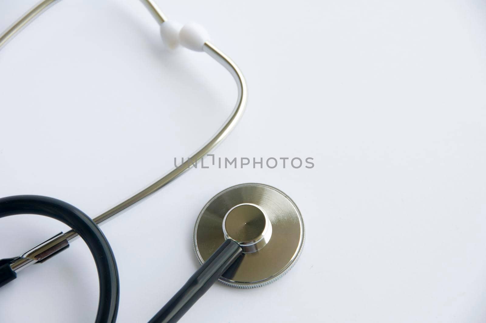 Stethoscope on white cover background with customizable space for text. Copy space and health concept.