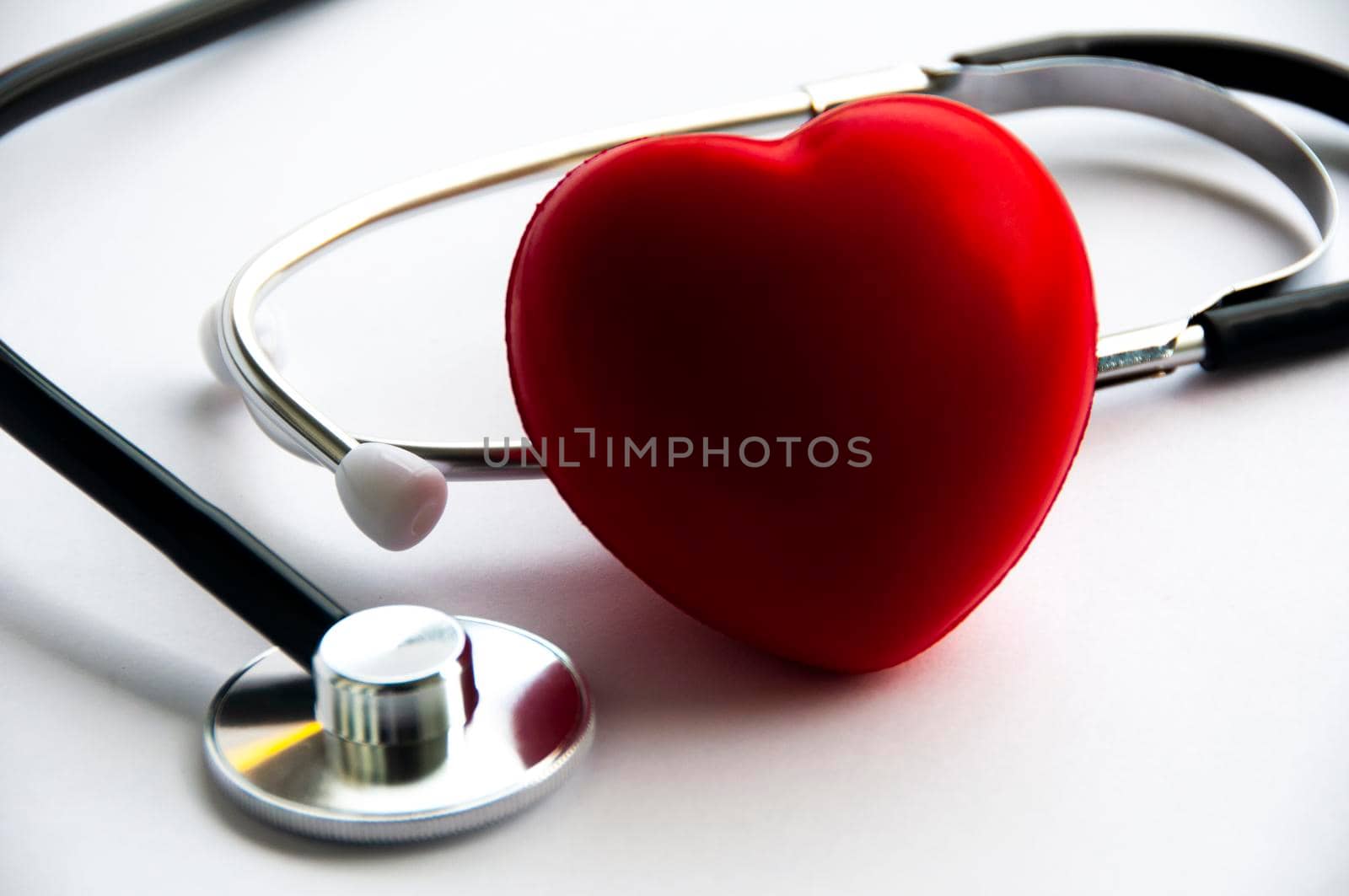 Stethoscope with heart shape on white background. Copy space and health concept.