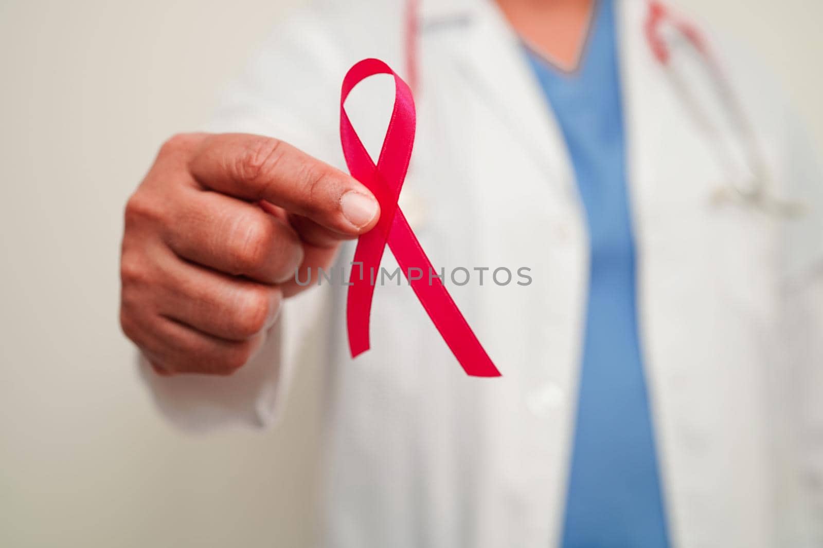 Asian woman doctor with pink ribbon, World Breast Cancer Day at October.