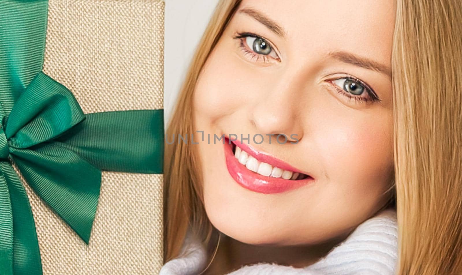 Winter holidays, present and Merry Christmas concept, happy woman smiling and holding wrapped gift box, close-up portrait