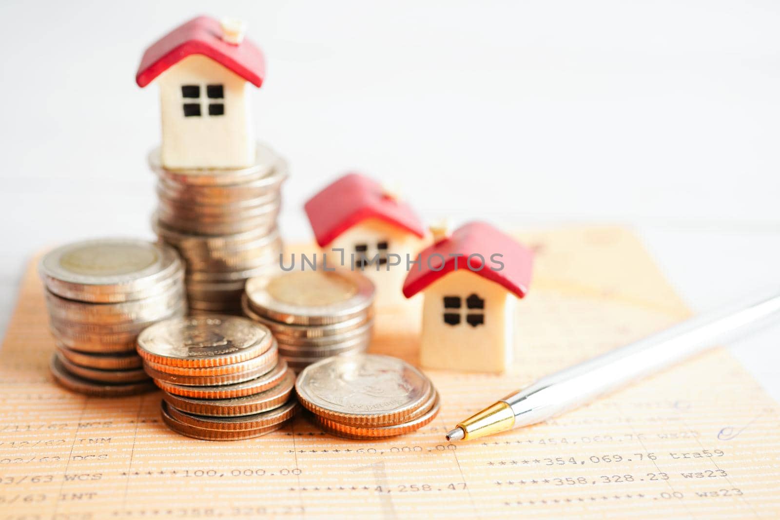 House on stack of coins, Investment property finance concept.