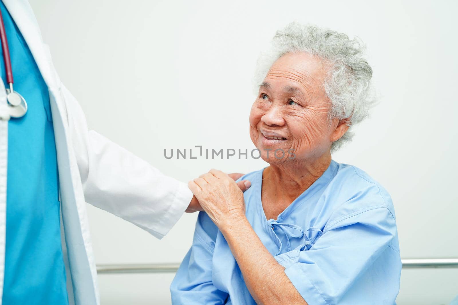 Doctor holding hands Asian elderly woman patient, help and care in hospital.