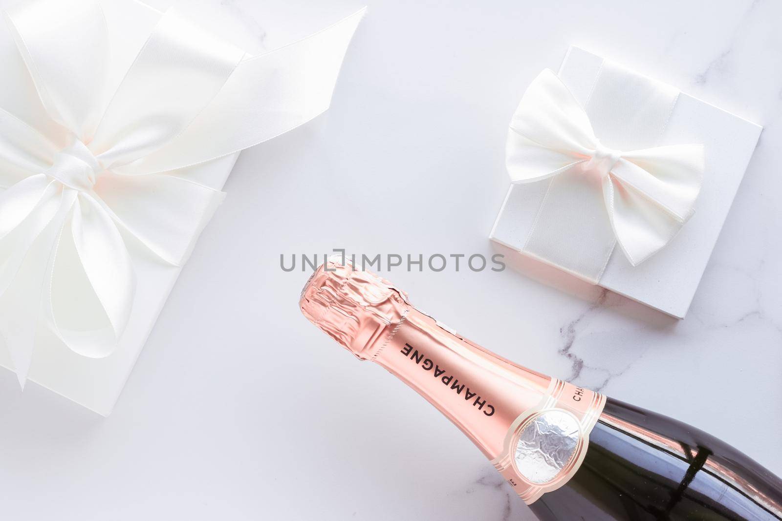 Champagne bottle and gift box on marble, New Years, Christmas, Valentines Day or wedding holiday present and luxury product packaging for beverage brand by Anneleven