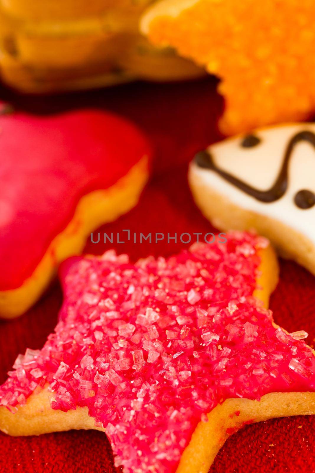 Assorted christmas cookies on red background.
