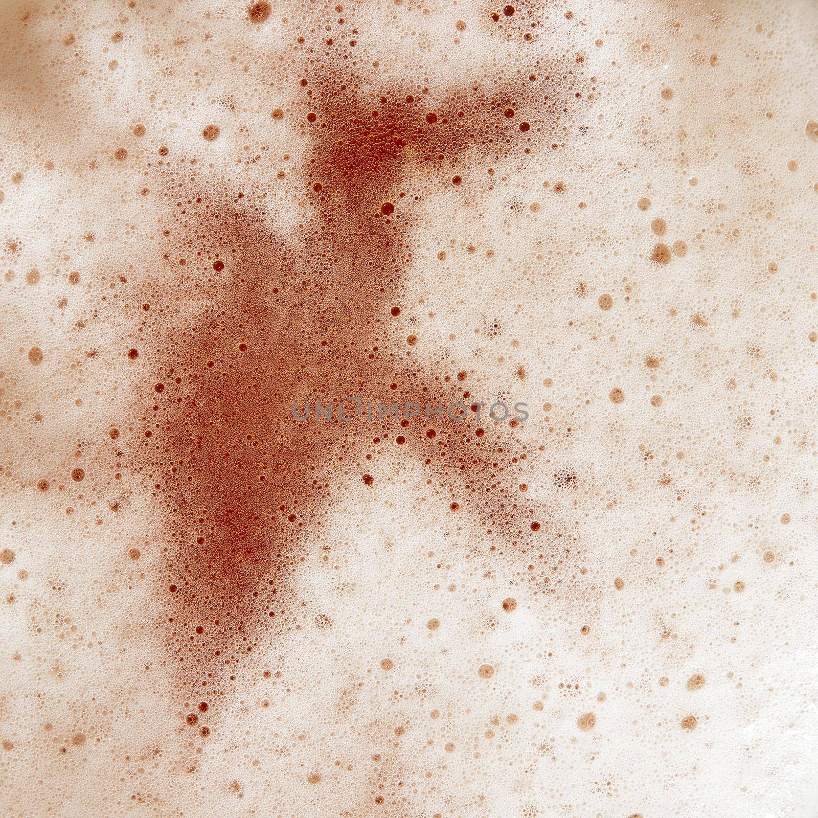 Beer foam top view. Soft fresh Foam on light beer. Bubble froth of beer. Beer foam texture background.