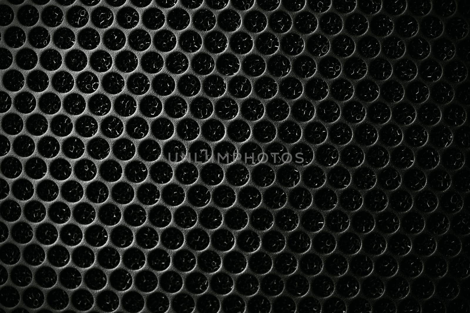 Safety net on the music speaker. Protective grid audio speakers. Close view of Black safety net. Metal perforated mesh, abstract pattern, Abstract black background. Professional audio equipment.