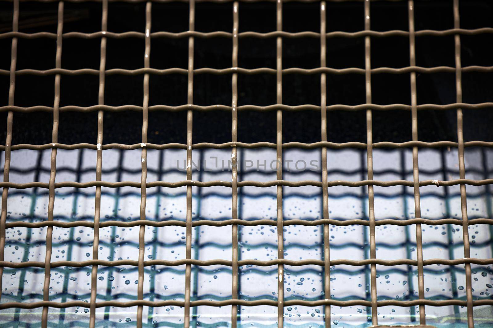 Protective grille on the windshield of an armored car. Police armored car with glass protection. MRAP Armored Transport Vehicle.