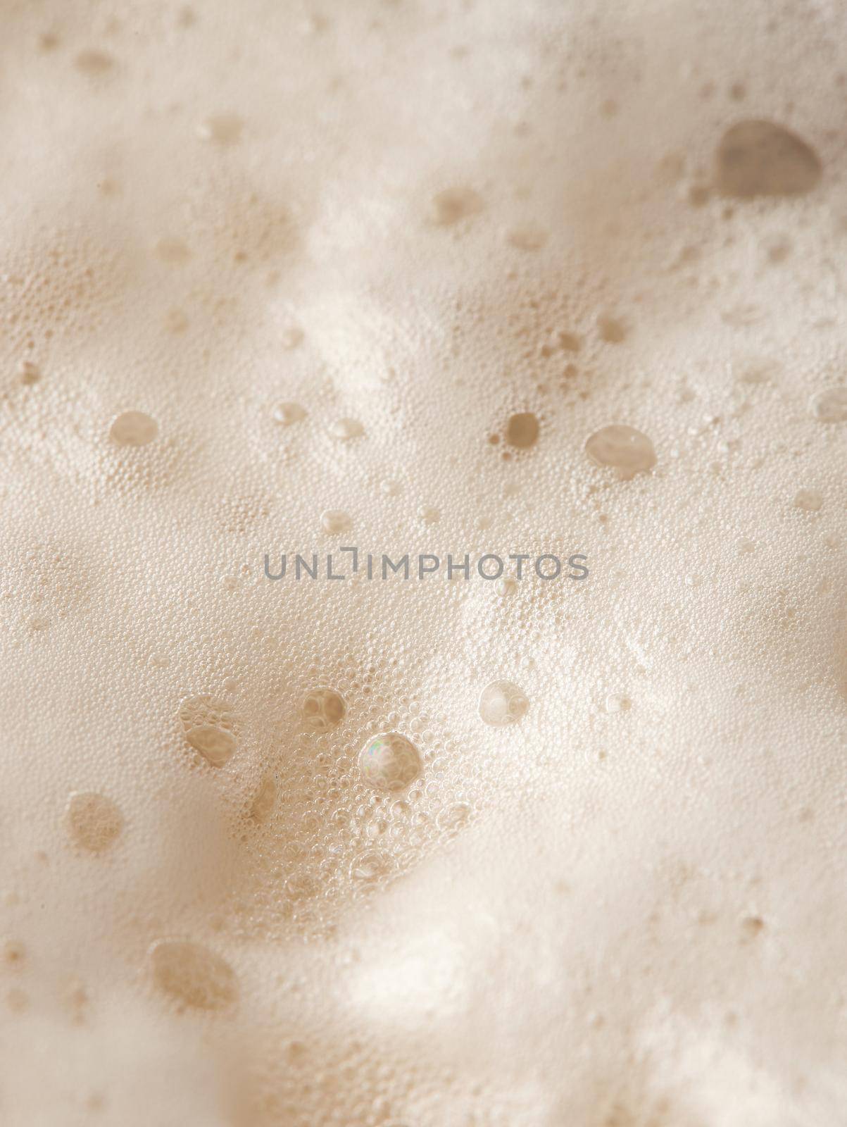 Beer foam top view. Soft fresh Foam on light beer. Bubble froth of beer. Beer foam texture background.