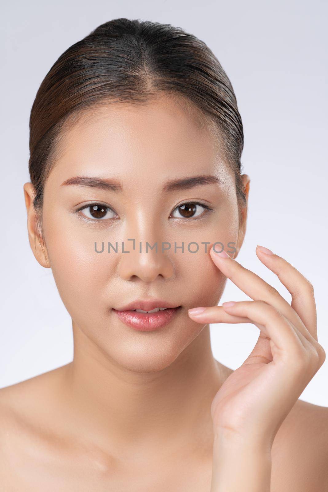 Portrait of gorgeous young girl posing beauty gesture with clean fresh skin. by biancoblue