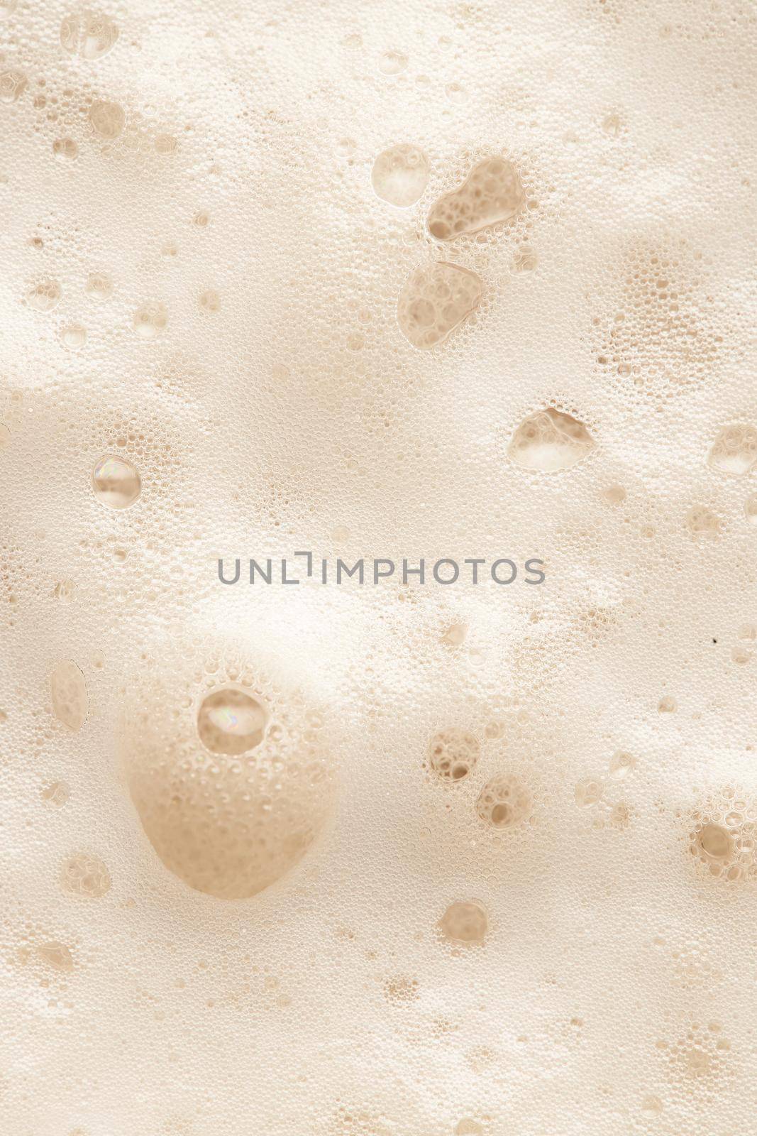 Beer foam top view. Soft fresh Foam on light beer. Bubble froth of beer. Beer foam texture background.