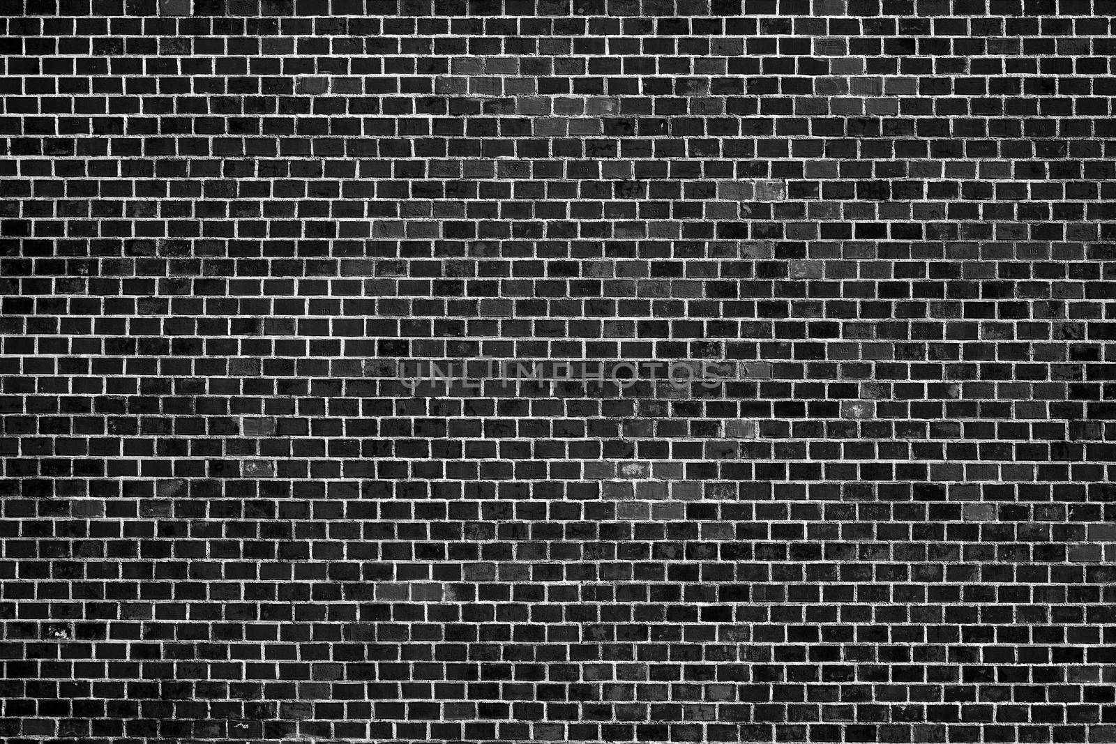 Old Black Brick Wall. An ancient fortress. Medieval brick building. Big Brick wall background texture.
