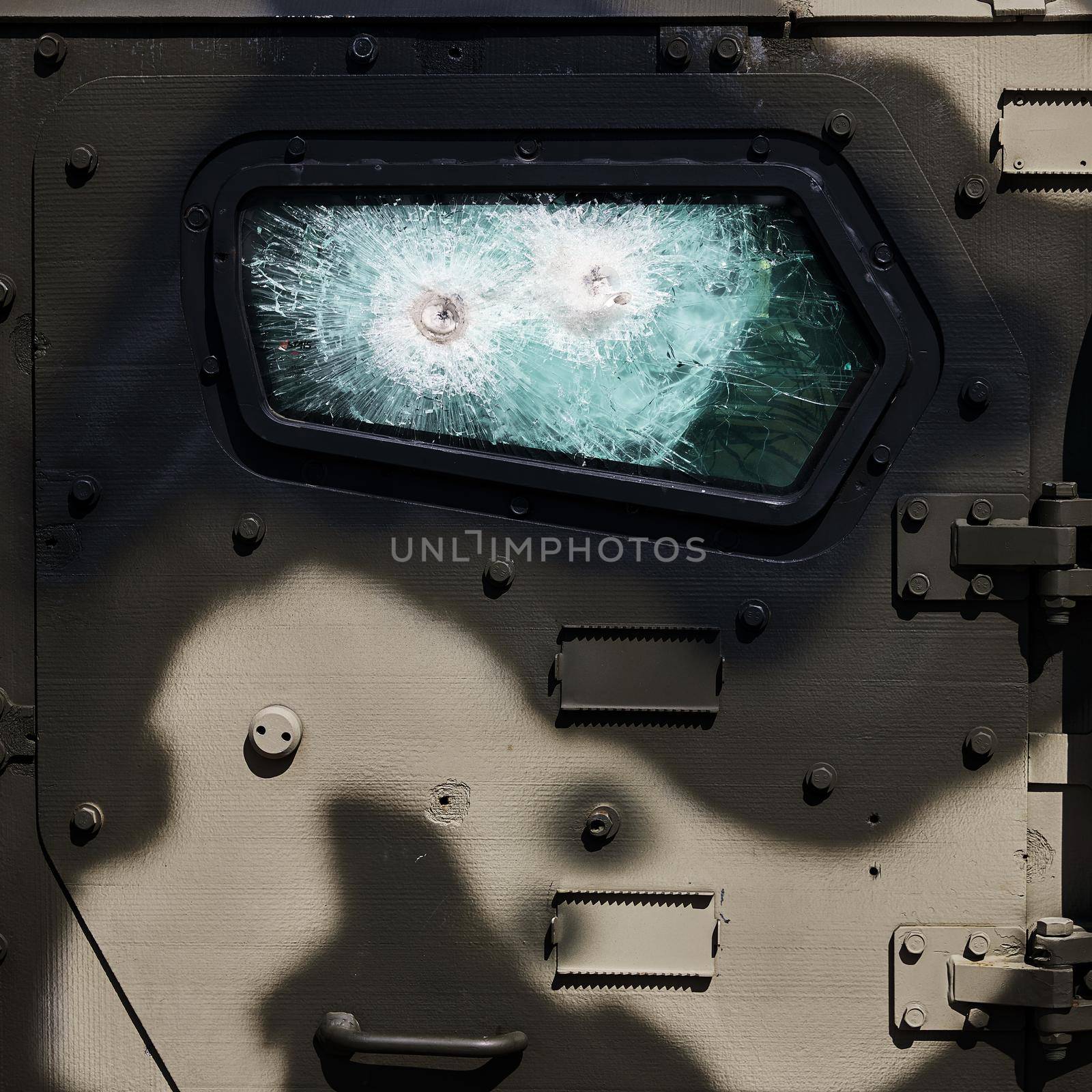 Armored car after the shelling. Bulletproof glass. Armored glass after of a direct hit from an automatic weapon. Safety glass after being hit by a bullet.