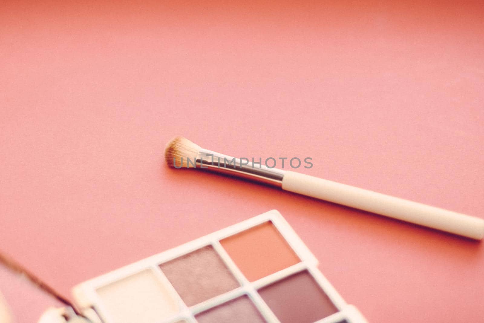Eyeshadow palette and make-up brush on orange background, eye shadows cosmetics product as luxury beauty brand promotion and holiday fashion blog design by Anneleven