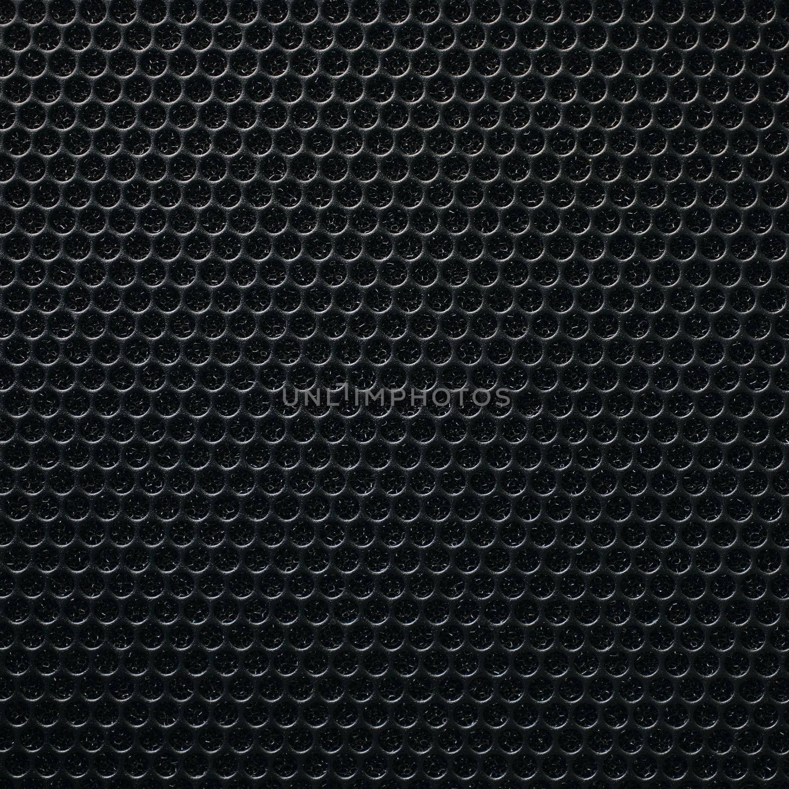 Safety net on the music speaker. Protective grid audio speakers. Close view of Black safety net. Metal perforated mesh, abstract pattern, Abstract black background. Professional audio equipment.