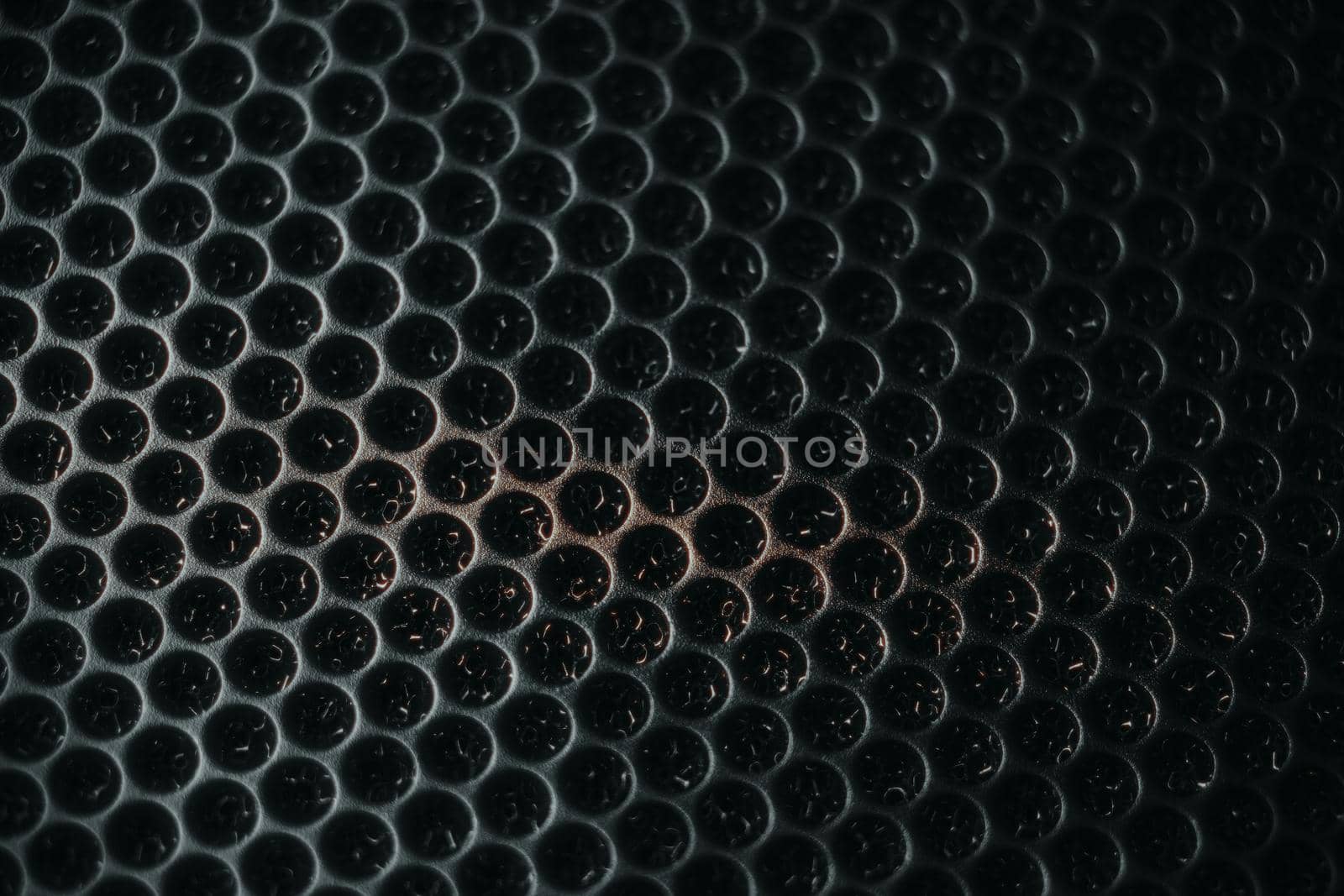 Safety net on the music speaker. Protective grid audio speakers. Close view of Black safety net. Metal perforated mesh, abstract pattern, Abstract black background. Professional audio equipment.
