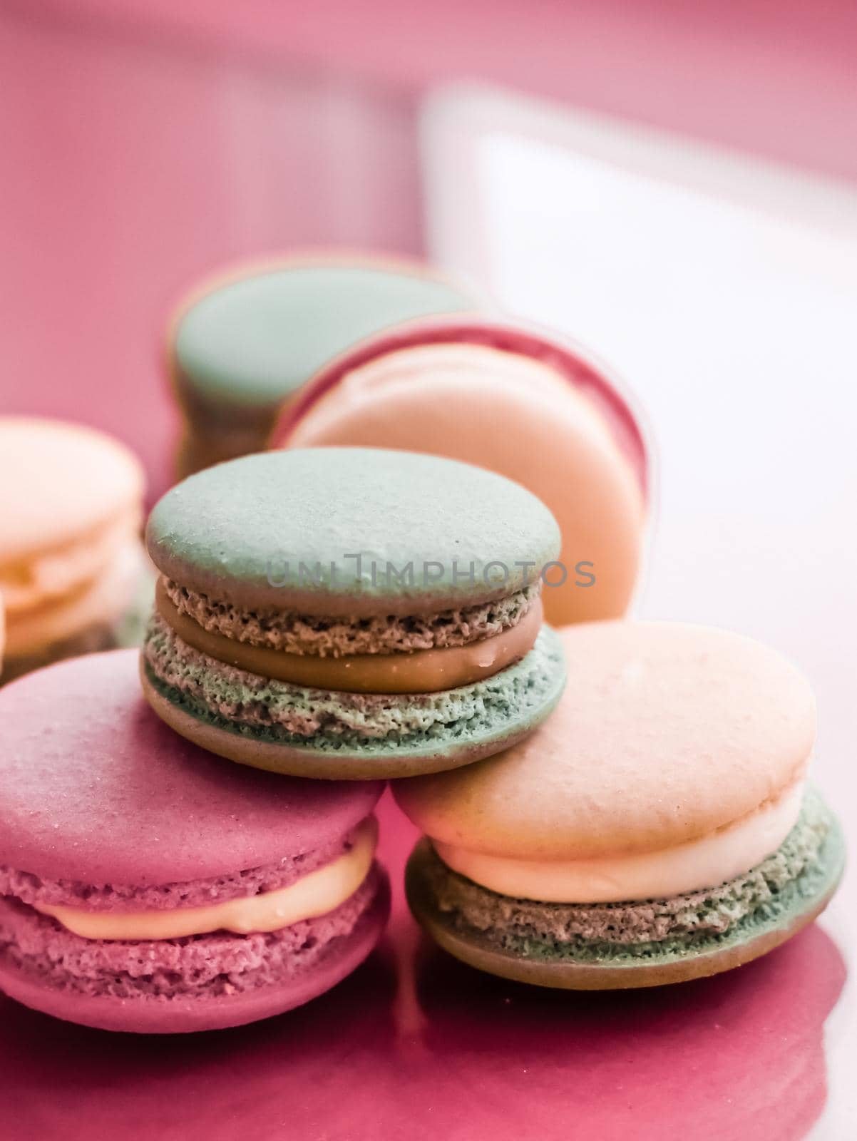 French macaroons on pastel pink background, parisian chic cafe dessert, sweet food and cake macaron for luxury confectionery brand, holiday backdrop design by Anneleven