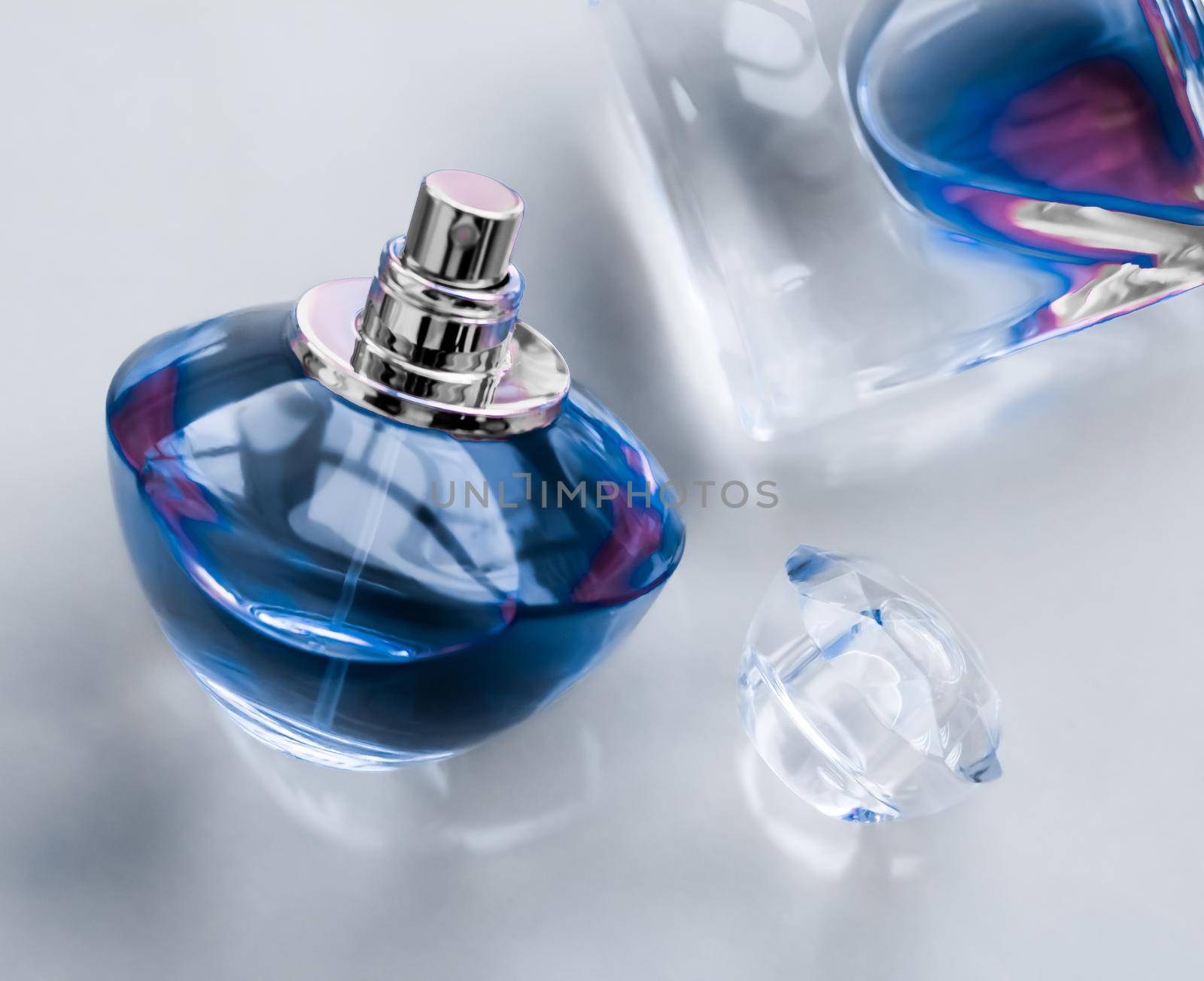 Perfumery, spa and branding concept - Blue perfume bottle on glossy background, sweet floral scent, glamour fragrance and eau de parfum as holiday gift and luxury beauty cosmetics brand design