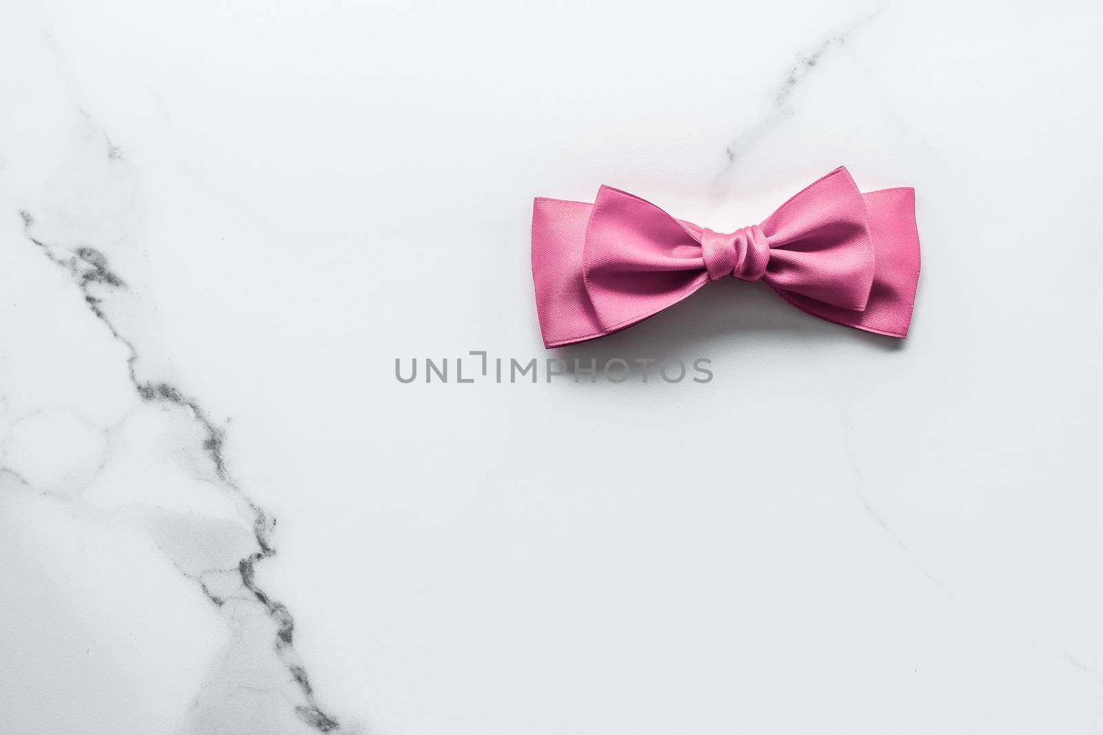 Birthday, wedding and girly branding concept - Pink silk ribbon and bow on marble background, girl baby shower present and glamour fashion gift decor for luxury beauty brand, holiday flatlay design