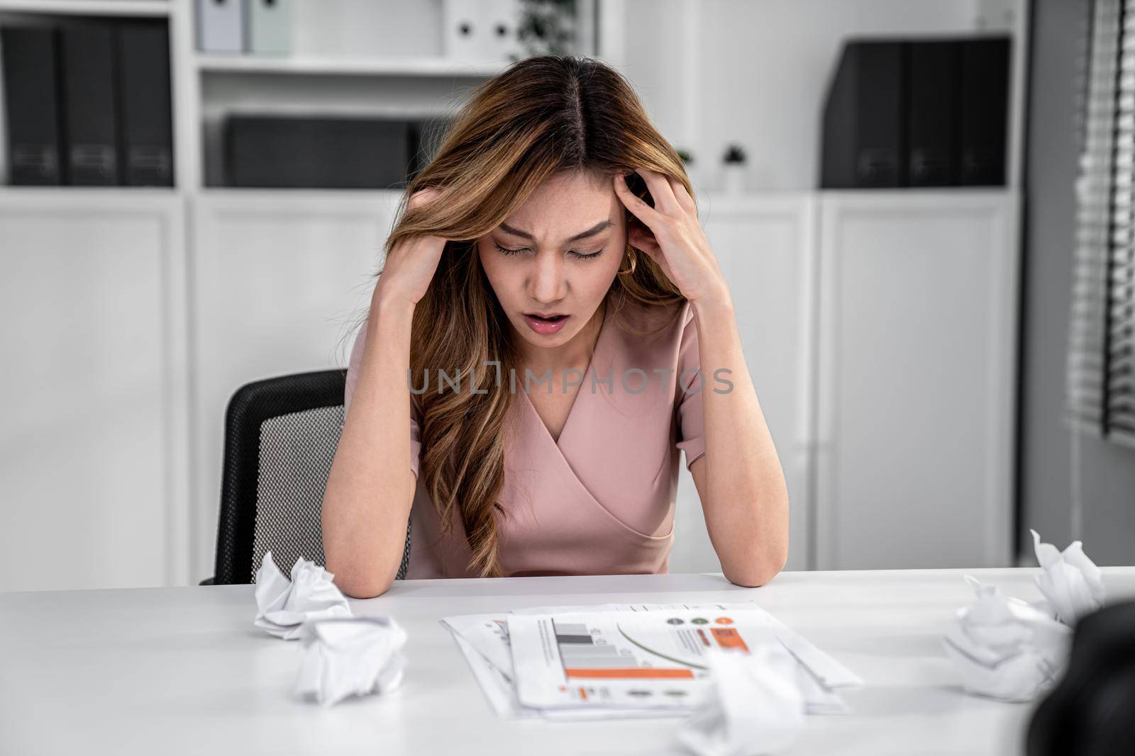 A competent female employee who has become completely exhausted as a result of overburdened work. Concept of unhealthy life as an office worker, office syndrome.