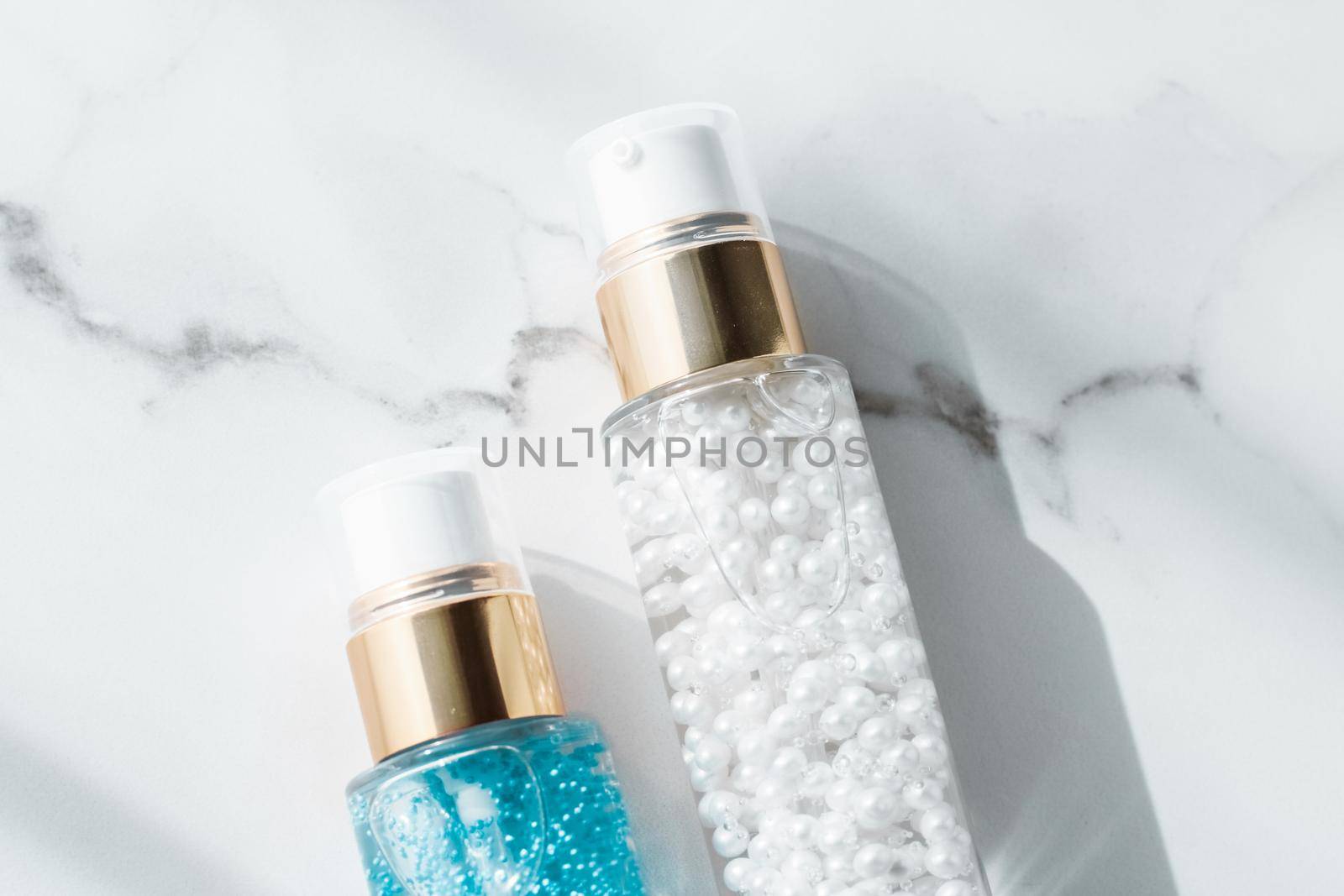 Cosmetic branding, packaging and make-up concept - Skin care serum and gel bottle, moisturizing lotion and lifting cream emulsion on marble, anti-age cosmetics for luxury beauty skincare brand design