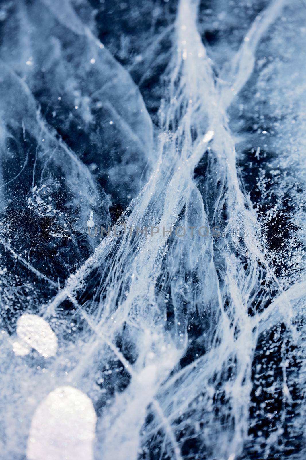 Texture of ice of Baikal lake in Siberia. blue lake ice.