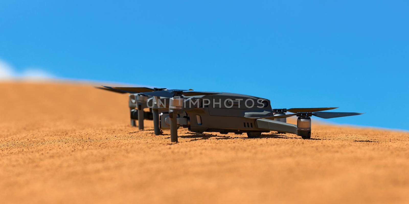Quadrocopters are built on the sand in the desert waiting for takeoff.