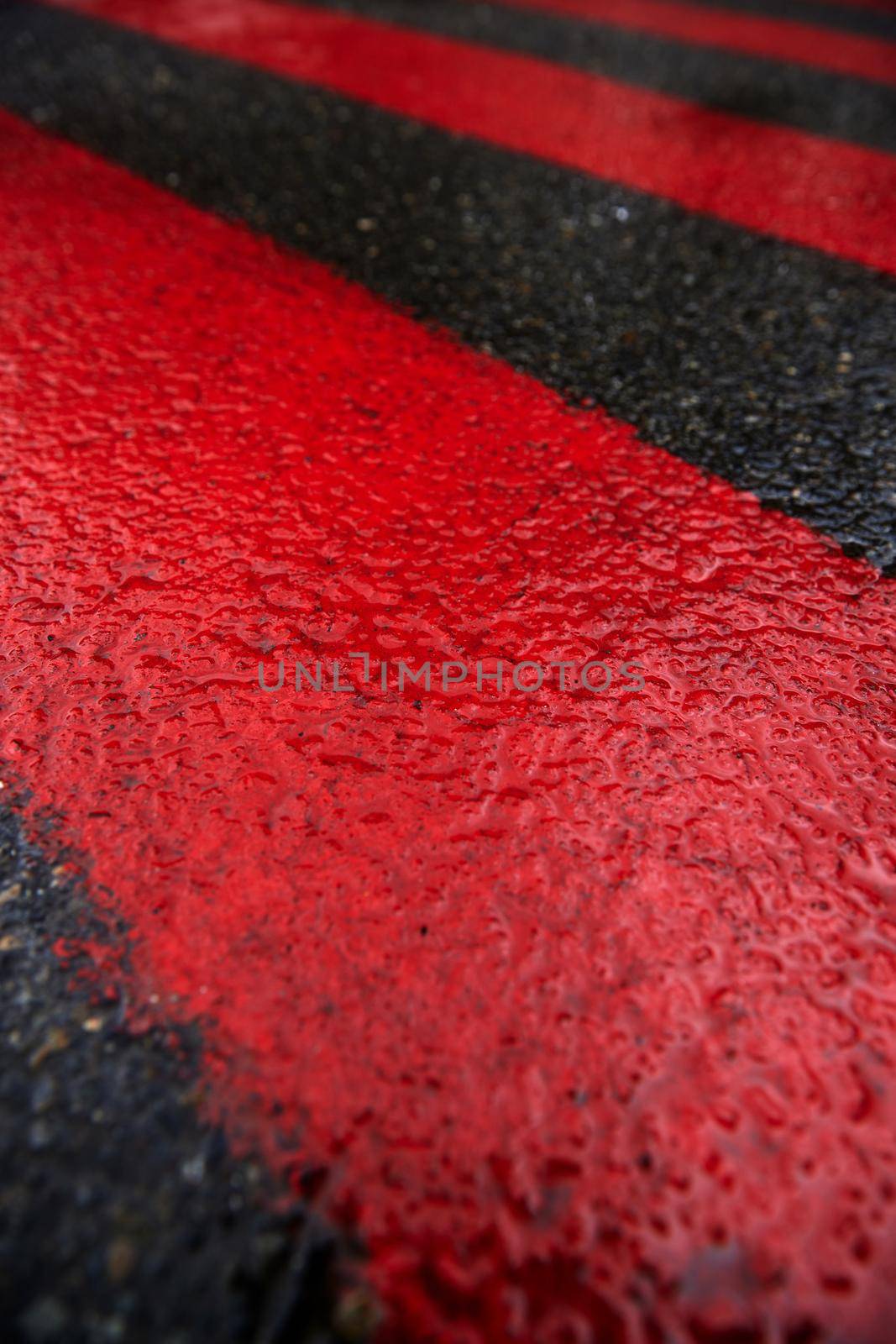Road marking for fire tracks parking. abstract background of red and white markings for fire fighting equipment on wet pavement by EvgeniyQW