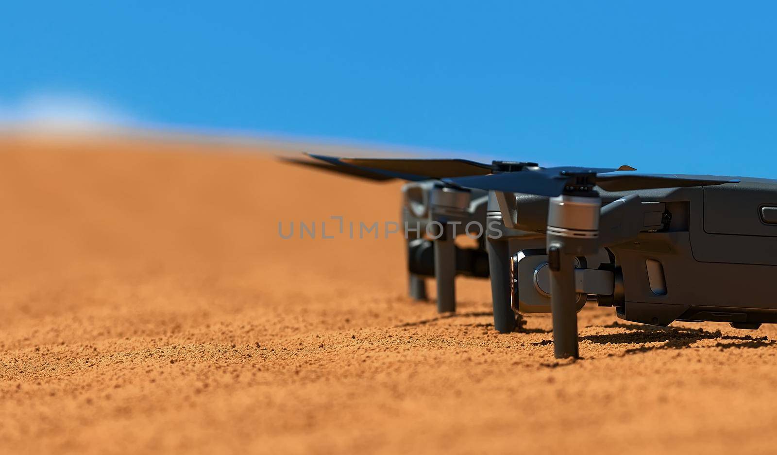 Quadrocopters are built on the sand in the desert waiting for takeoff.