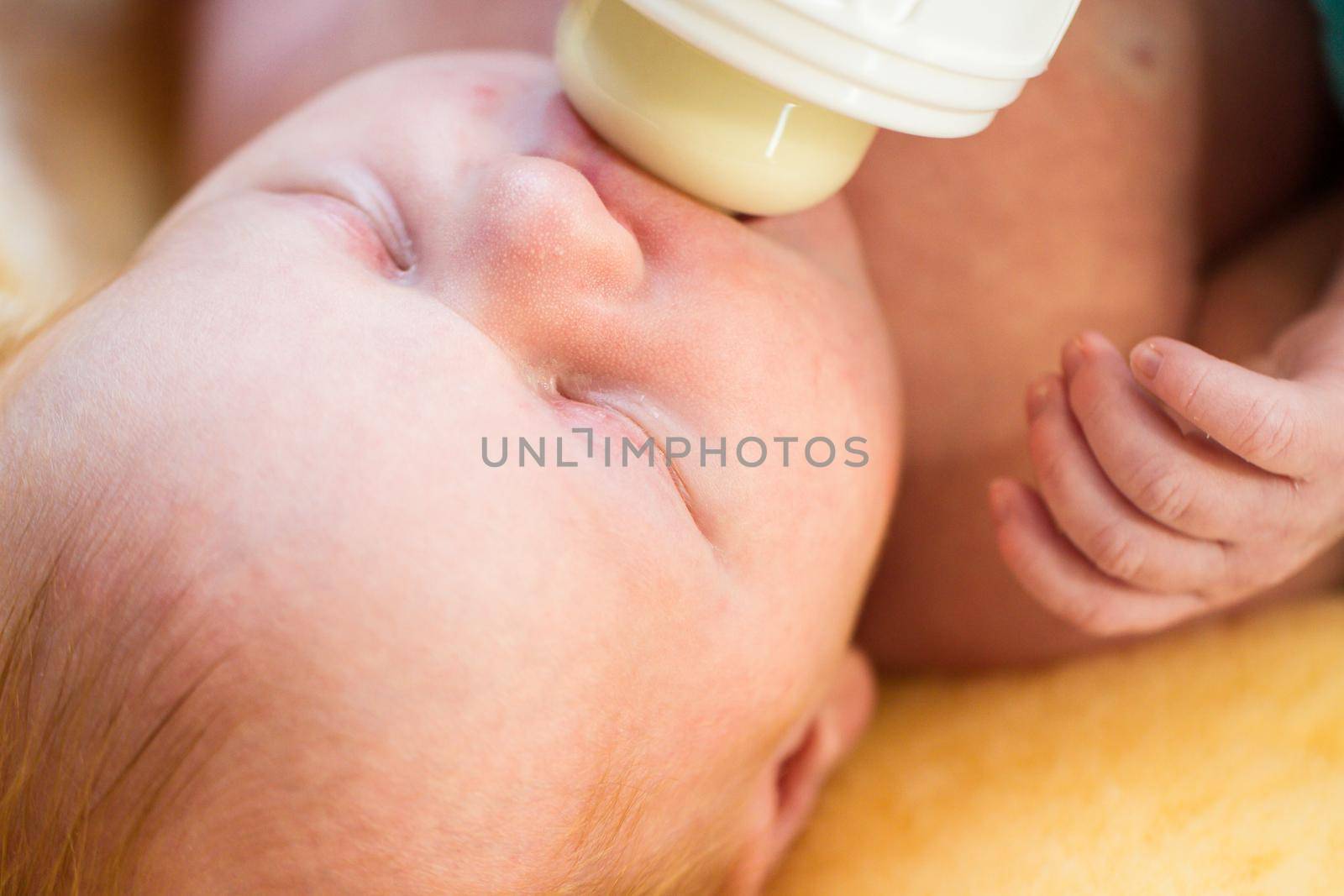 Newborn baby girl at feeding time.