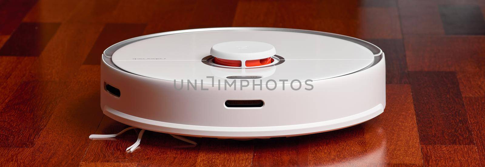 Smart Robot Vacuum Cleaner Xiaomi roborock s5 max on wood floor. Robot vacuum cleaner performs automatic cleaning of the apartment. 04.12.2020, Rostov region, Russia by EvgeniyQW