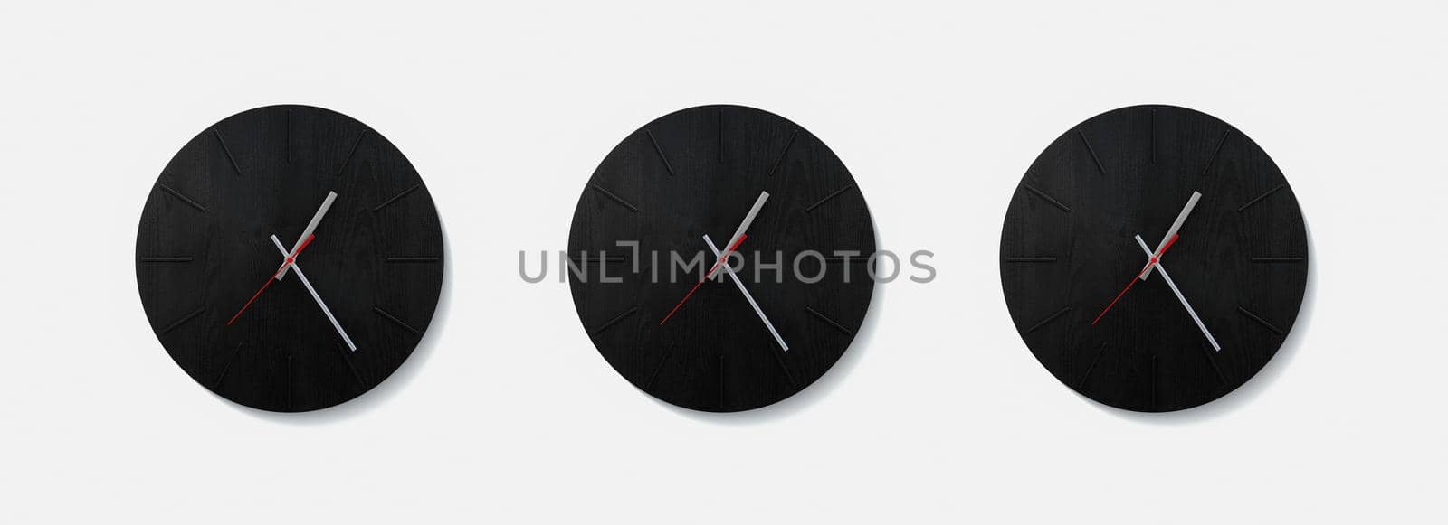 Stylish black round clock on a white wall. Time on the wall as an element of the interior. Simple modern round clock on white wall by EvgeniyQW