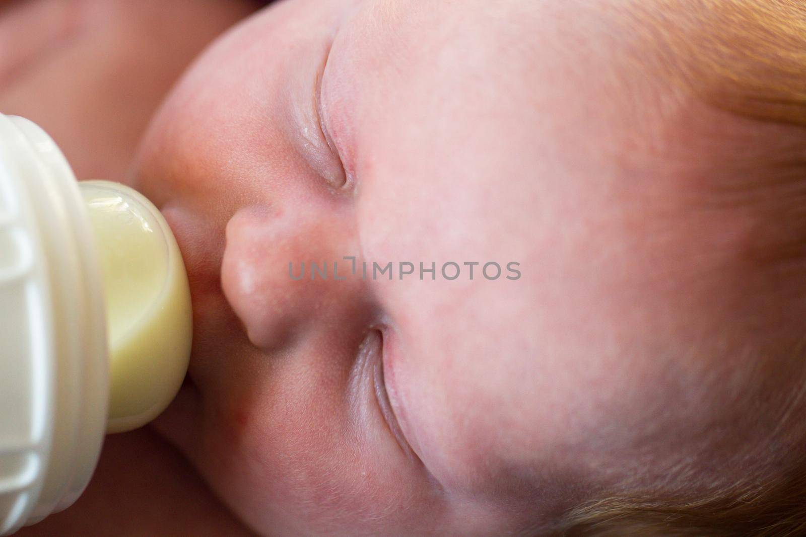 Newborn baby girl at feeding time.