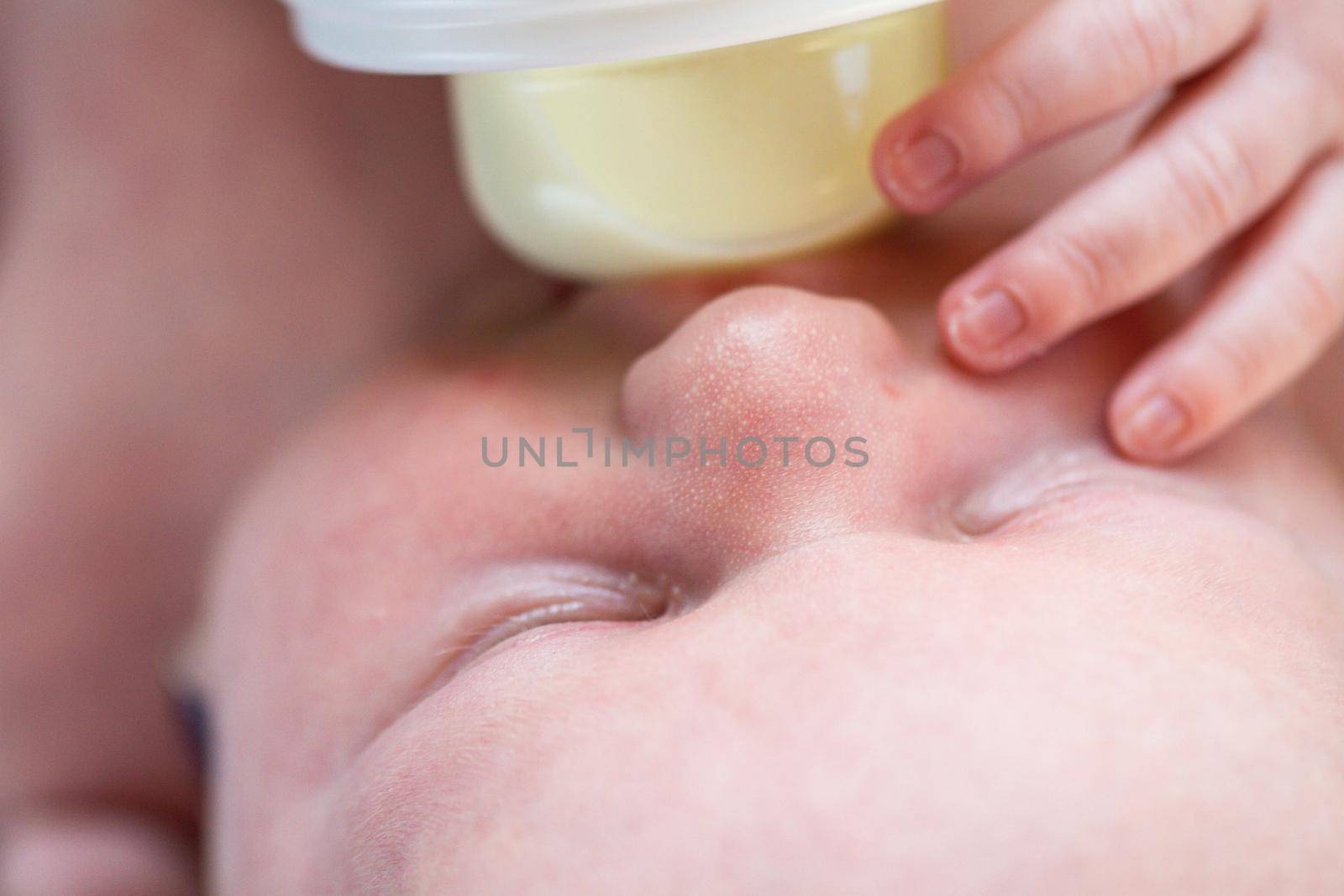 Newborn baby girl at feeding time.