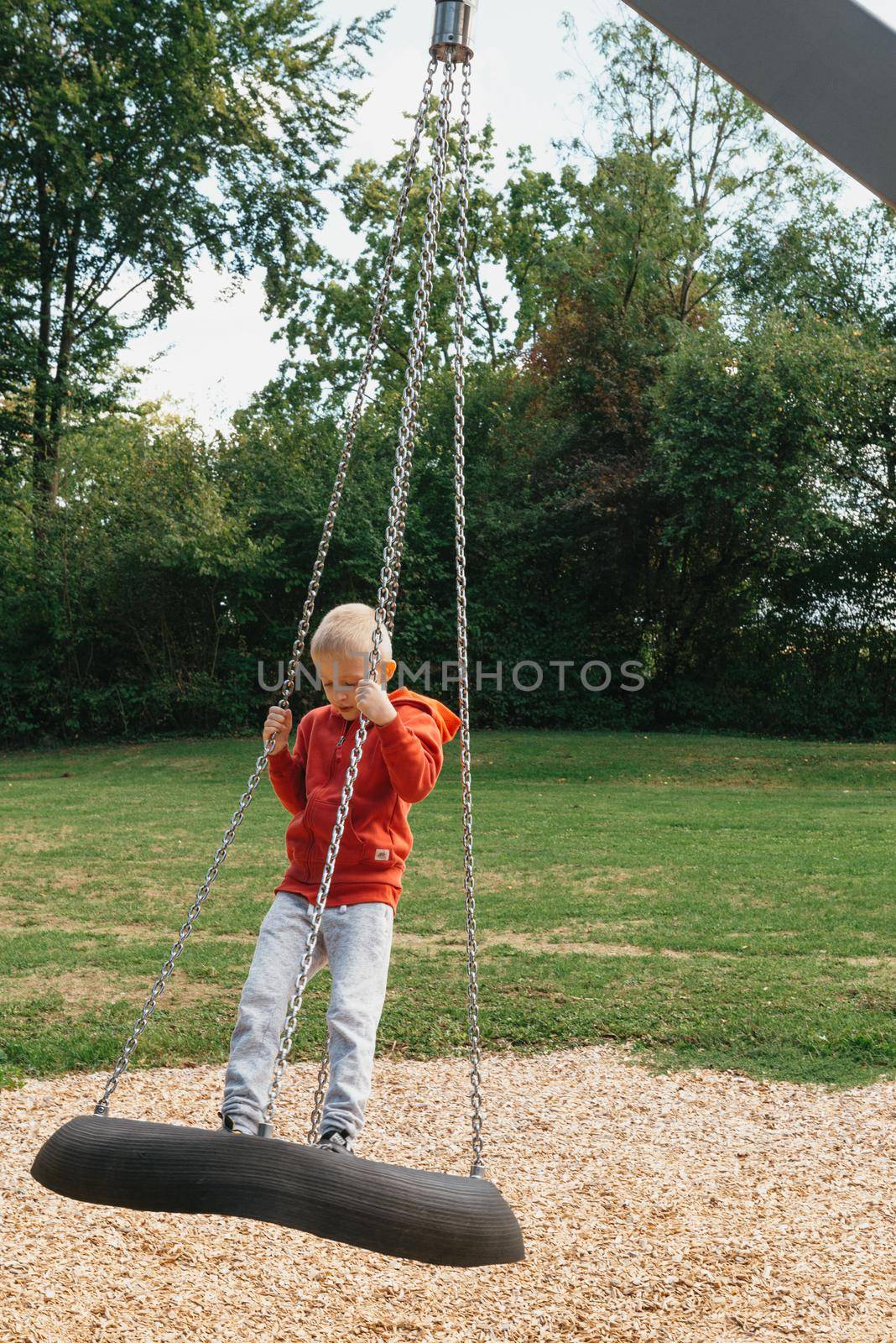 Funny cute happy baby playing on the playground. The emotion of happiness, fun, joy. Smile of a child. boy playing on the playground.