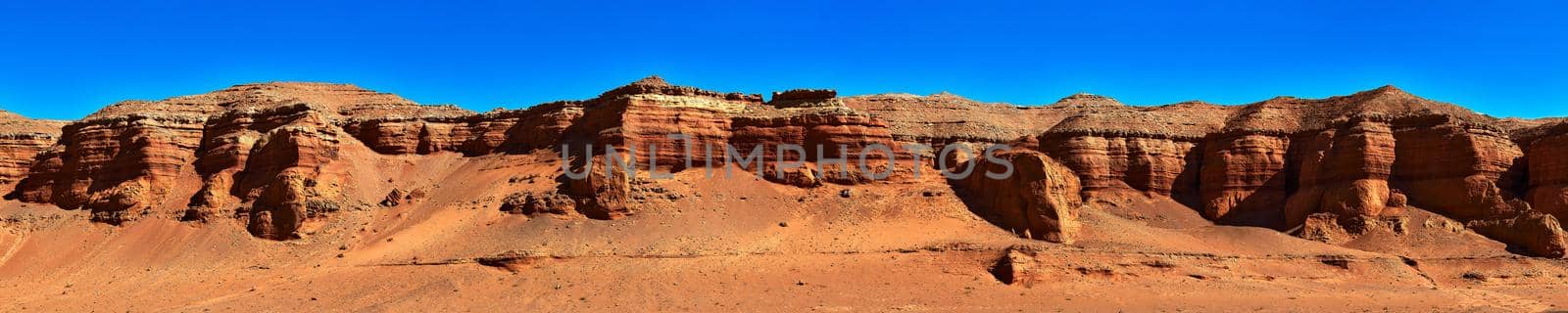 Herman Cav Canyon at sunset. South Gobi, Mongolia. Herman Tsav Canyon. Red Sandstone plateau, Martian landscape. The site of many paleontological finds. Cemetery of dinosaurs.