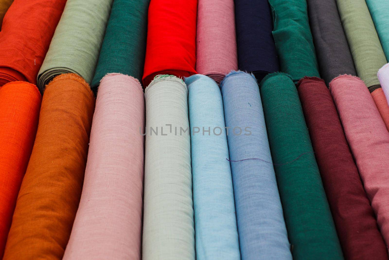 Detailed close up view on samples of cloth and fabrics in different colors found at a fabrics market.