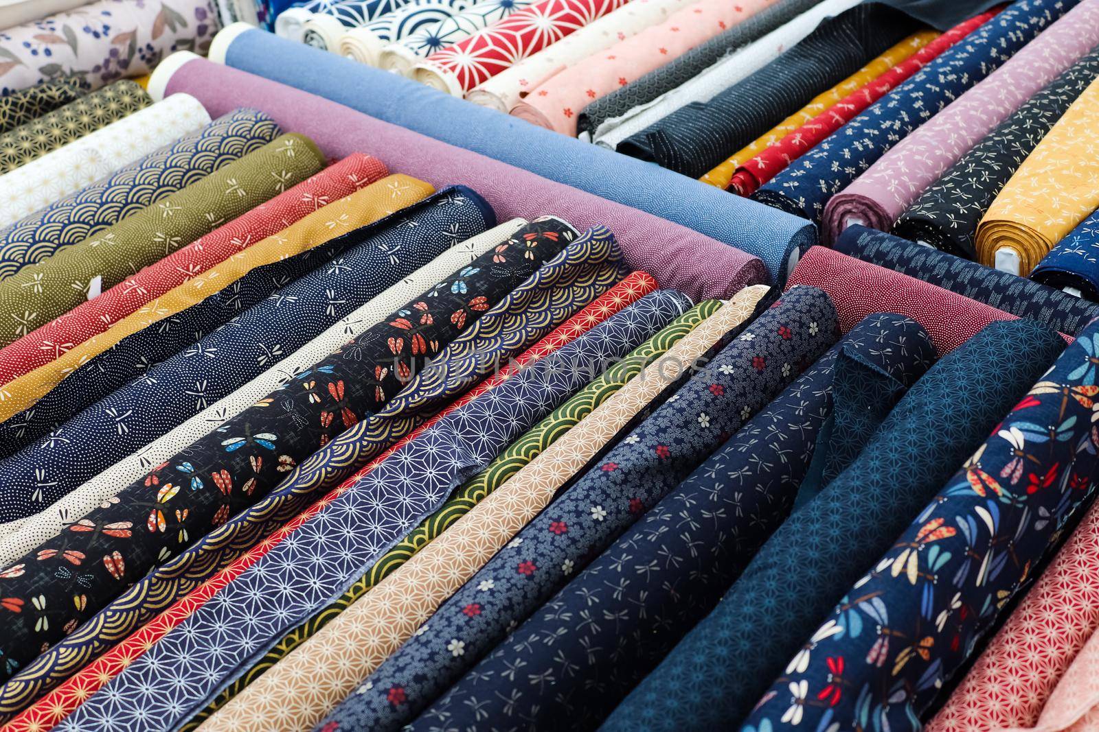 Detailed close up view on samples of cloth and fabrics in different colors found at a fabrics market.