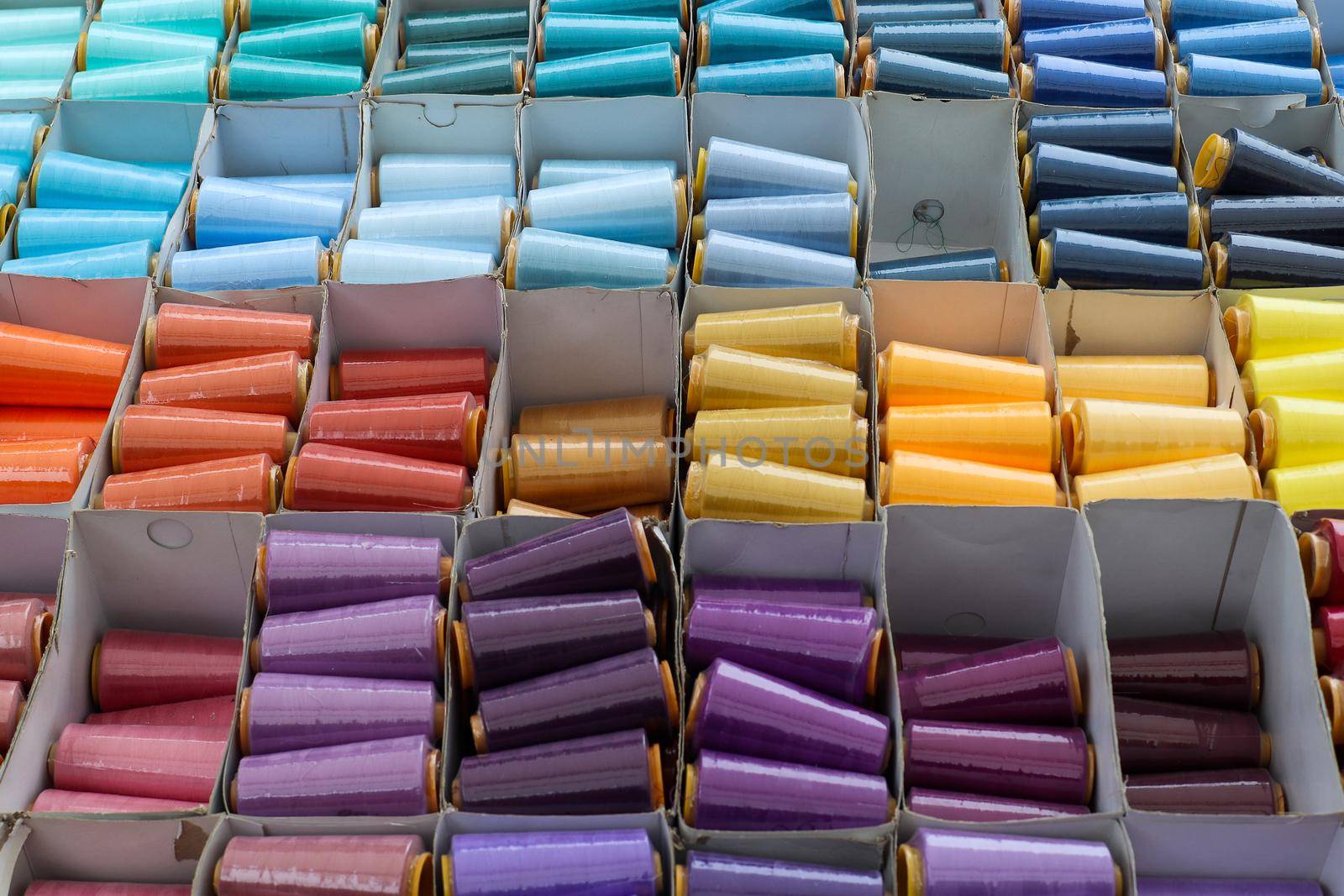 Detailed close up view on samples of cloth and fabrics in different colors found at a fabrics market.